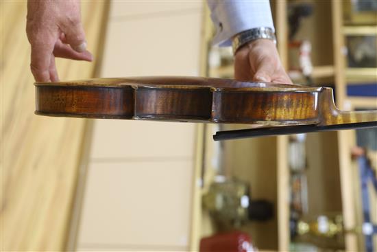A late 19th century German violin, bears Stradivarius label, cased with bow, back 36cm